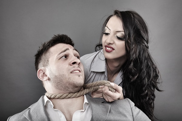 Man being tied by his neck with a rope by a woman