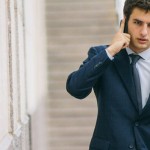 Young businessman talking with his phone in a street