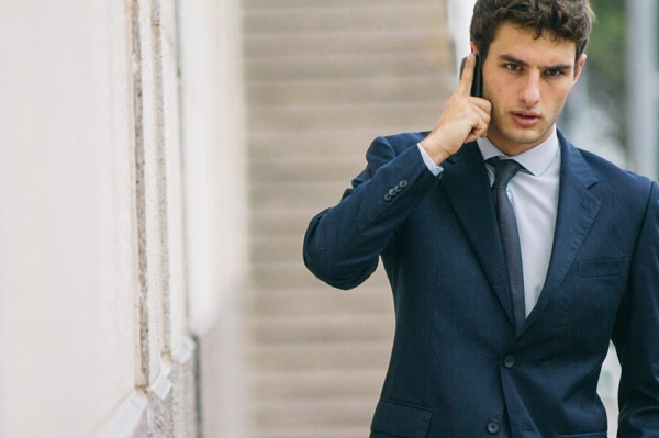 Young businessman talking with his phone in a street