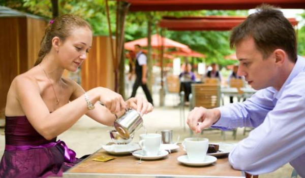 Romantic couple in Paris, having breakfast in a Parisian street cafe
