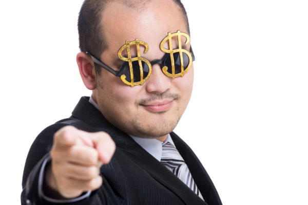 Rich businessman wear dollar sign glasses pointing to you