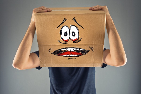 Man with cardboard box on his head and terrified look skethed