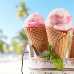 Fruit ice cream with blur beach as background. Served on wooden planks