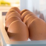 Open fridge filled with eggs