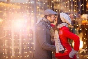 Young pregnant couple portrait in winter town_sirabee