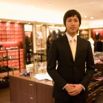 Male salesclerk at men's clothing counter