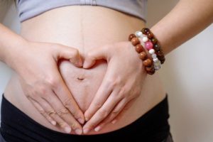 Closeup Asian pregnant woman in studio on white background