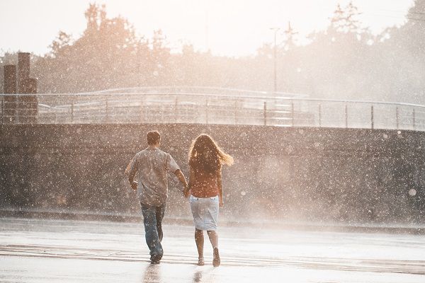 couple walking under summer rain