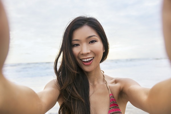 Asian Woman Girl at Beach Taking Selfie Photograph