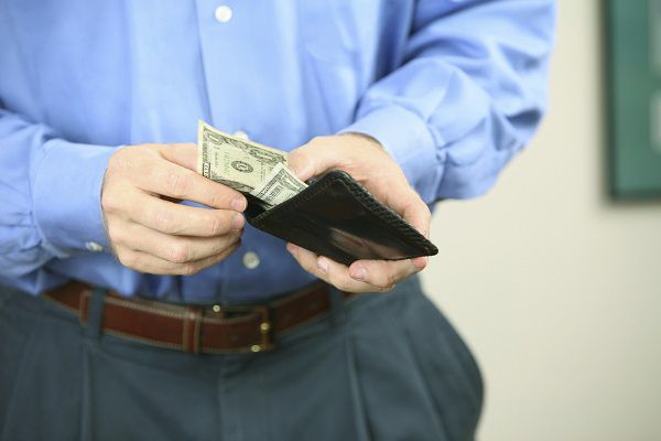Mid section view of a mid adult man holding a wallet