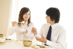 Man and woman eating meal at dining table