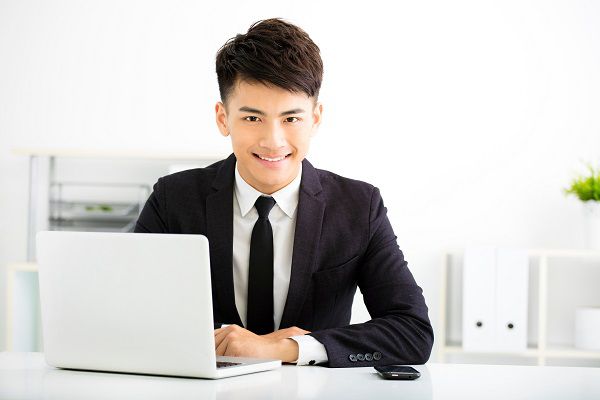 young smiling businessman working in office