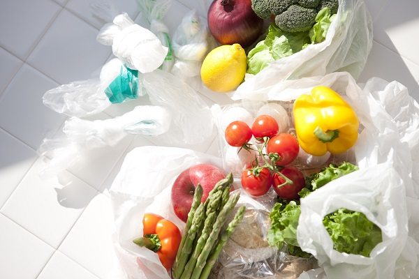 Fruit, vegetables and eggs with plastic shopping bags