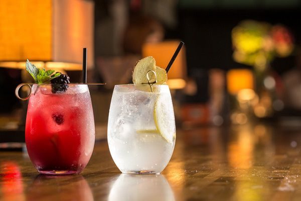 Two glasses of frozen lemonade on bar counter