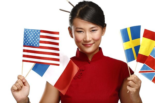 Beautiful asian woman showing multicolor international flags