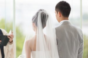 Couple in white wedding ceremony