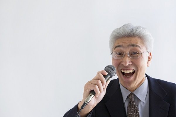 Businessman singing into microphone