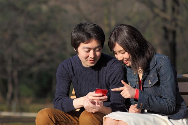 young couple looking at smartphone