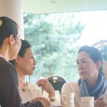 Three women talking siriously at a cafe shop