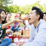 happy young friends enjoying  healthy picnic