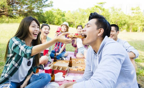 happy young friends enjoying  healthy picnic