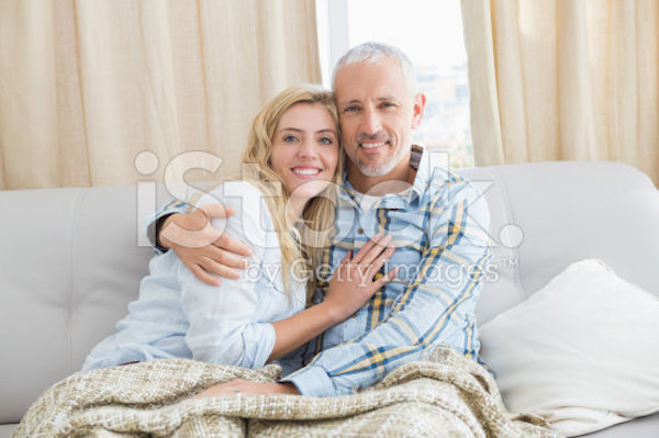 stock-photo-49068100-happy-couple-relaxing-on-the-couch
