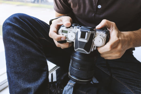 Professional photographer concentrate and continue his passion for photography with soft-focus in the background. over light and film tone